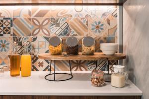 a shelf with dishes and other items on it at Quaint Boutique Hotel Sannat in Sannat