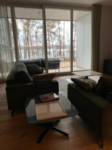 a living room with a couch and a coffee table at Marina Apartment am See mit Pool und Sauna in Bad Saarow