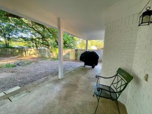 a bench sitting on the side of a house at Cottage Hill Comfort in Mobile