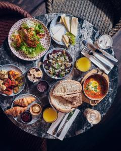 a table with many plates of food on it at Fabric Hotel - an Atlas Boutique Hotel in Tel Aviv