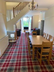 a dining room and living room with a table and chairs at Berkeley House in Keswick