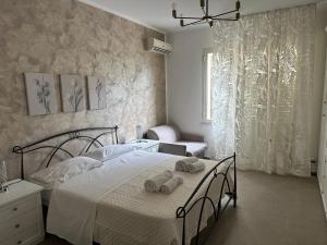 a bedroom with a bed with two stuffed animals on it at CH Exclusive Apartments in Cefalù