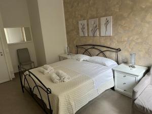 a bedroom with a bed with towels on it at CH Exclusive Apartments in Cefalù