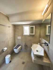 a bathroom with a sink and a toilet at Folegandros residence/Karavostasi in Karavostasi