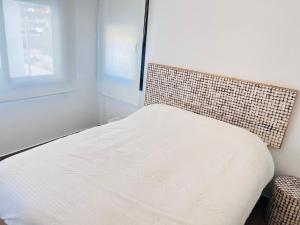 a white bed in a room with a window at Sevenhouses Pilar de La Horadada in Pilar de la Horadada +12 photos
