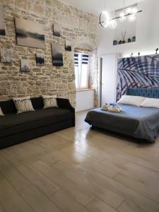 una camera con letto e muro di mattoni di Maison Divino a Trani