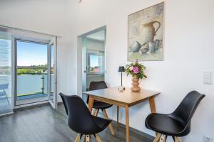 a dining room with a table and chairs at Haus Sohl 2 in Friedrichshafen