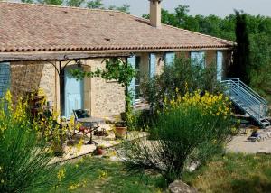 a stone house with a porch and a patio at Domaine de "Creva-Tinas" in Pouzols-Minervois
