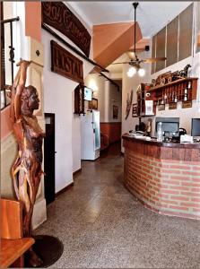 a fast food restaurant with a kitchen and a bar at Hostal Las Carretas in San Miguel de Tucumán
