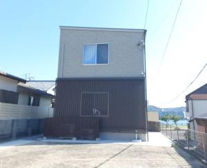 a house with a window on the side of it at 鶴城丸（KAKUJYOMARU） in Karatsu