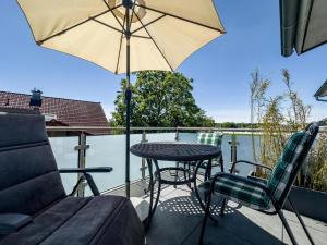 a patio with a table and chairs and an umbrella at Haus Sohl 1 in Friedrichshafen
