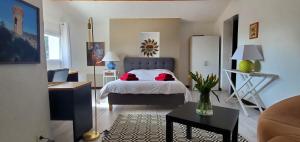 a bedroom with a bed with red pillows on it at L'AMBROISINE in Saint-Ambroix