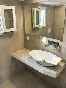 a bathroom with a sink and a mirror at Folegandros residence/Karavostasi in Karavostasi