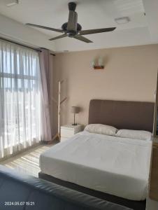 a bedroom with a bed and a ceiling fan at Nuha Studio Stay at D'perdana Apartment in Kota Bharu
