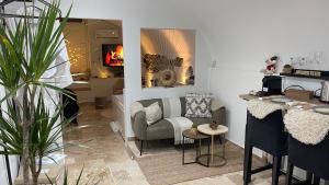 a living room with a chair and a table at Le Petit Bijou di Dolceacqua, per un momento romantico in Dolceacqua
