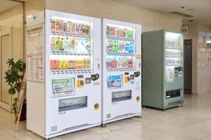 two white refrigerators are standing in a room at Hotel 1-2-3 Kurashiki in Kurashiki