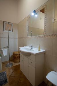 a bathroom with a sink and a mirror at Urban Beach - Casa Amarela in Carvoeiro