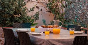 a table with orange juice and a basket of food at Casa Amarela by Urban Beach Rentals in Carvoeiro
