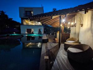 a house with a swimming pool at night at Handagedara Resort & Spa in Mirissa