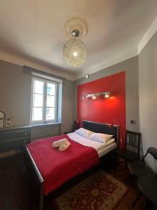 a bedroom with a bed with a red wall at Chmielna Guest House in Warsaw