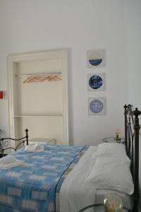 ein Schlafzimmer mit einem Bett mit einer blauen und weißen Decke in der Unterkunft Il Teatro Rooms in Catania