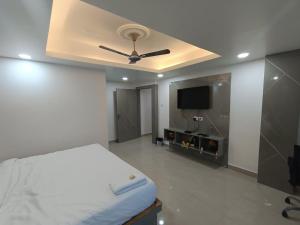 1 dormitorio con 1 cama y ventilador de techo en Stayvilla en Ranchi