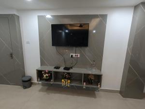 a living room with a tv on a wall at Stayvilla in Rānchī