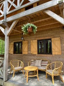 a patio with two chairs and a table and a bench at Na Las Czas in Sompolno