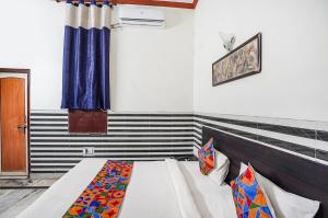 a bedroom with a bed in a room at FabHotel Sarwan in Agra