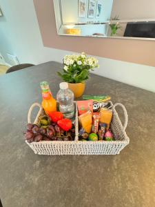 a basket of fruit and juice on a table at Garden Place in Clevedon