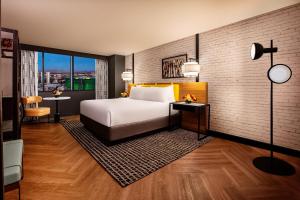 a hotel room with a bed and a large window at New York-New York in Las Vegas