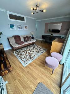 a living room with a couch and a table at Garden Place in Clevedon