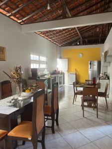 a kitchen and dining room with a table and chairs at Casa Dona Amélia in Barreirinhas