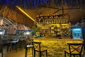 a bar with tables and chairs in a restaurant at Moni Hotel in Marmaris