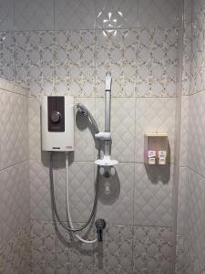 a shower in a bathroom with a soap dispenser at Lanta for Rest Boutique in Ko Lanta