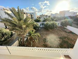 ariale Aussicht auf einen Garten mit Palmen und Gebäuden in der Unterkunft Anis 4 in Sousse