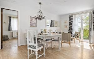 福堡Pet Friendly Home In Faaborg With Wifi的一间有白色桌子和椅子的餐厅