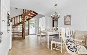 福堡Pet Friendly Home In Faaborg With Wifi的一间有白色桌子和椅子的餐厅