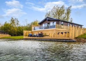 a house on the edge of a body of water at Noahs Retreat in Laceby