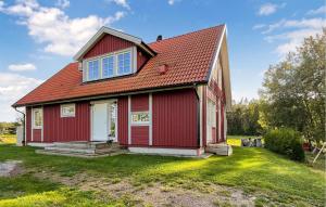 a red house with a red roof at Cozy Home In Nykping With House Sea View in Oxelösund