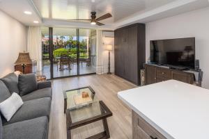 a living room with a couch and a tv at Kamaole Sands 1-305 in Wailea