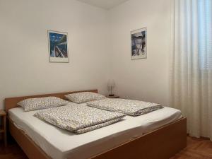 a bed in a bedroom with two pillows on it at Apartment LAGUNA 37 in Izola +24 photos