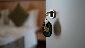 a key to a bedroom door with a keychain at Hotel Nuovo Sole HNS in Bovolone