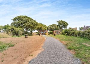 a gravel road leading to a house at Calvesland Hideaway in Manorbier