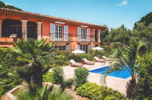 a house with a swimming pool in front of it at Domaine de l'Astragale in Saint-Tropez