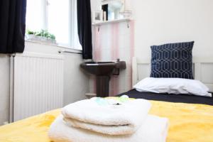 a room with towels on a table with a bed at Pebbles guest house room 15 in Southampton