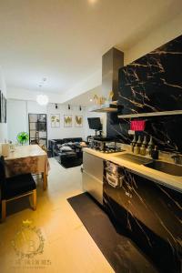 a kitchen with a stove and a dining room at Azure Urban Resort Condo Parañaque near NAIA Airport Free Highspeed WIFI and Netflix in Manila