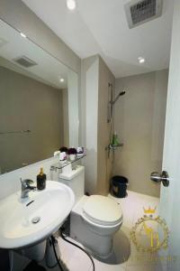 a bathroom with a white toilet and a sink at Azure Urban Resort Condo Parañaque near NAIA Airport Free Highspeed WIFI and Netflix in Manila