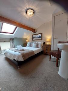 a bedroom with a bed and a sink in it at All Seasons Guest House in Windermere