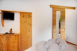 a room with a bed and a tv at Ferienhaus Plattner in Oetz +20 photos